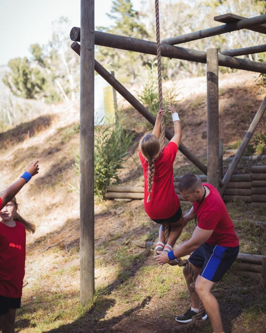 Trainer instructing a child during boot camp activity